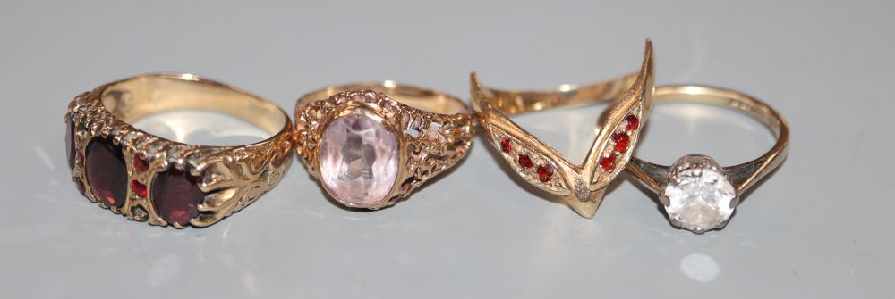 Four assorted 9ct gold and gem set dress rings including Victorian style garnet ring, gross 12.8 grams.